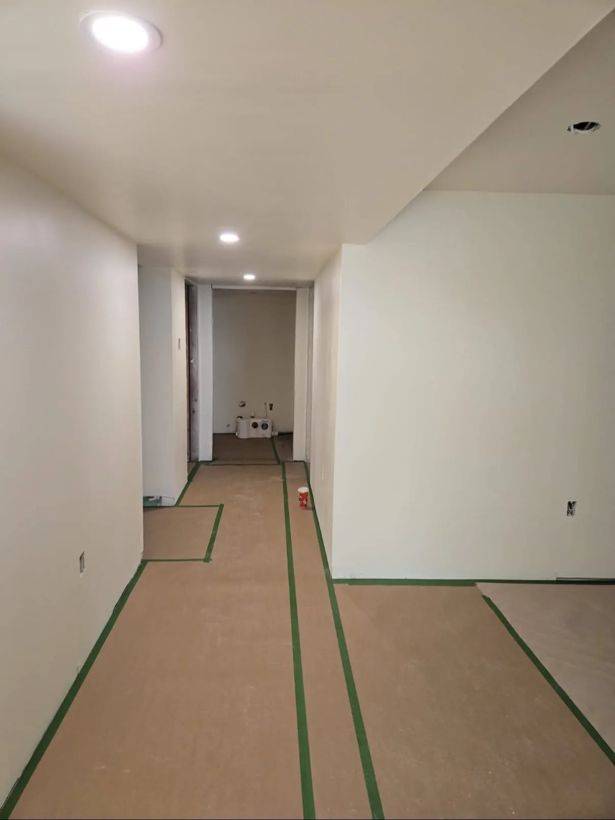 Finished basement renovation with new flooring and pot lighting